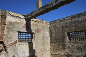 Interior view of a dilapidated building with rustic bricks and lattice windows, Old silk factory,