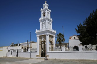 Church of Agia Paraskevi, A magnificent white church tower rises into the clear blue sky, village