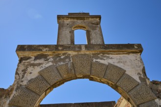 Abandoned stone archway under a clear blue sky, showing signs of weathering, Old Silk Factory,