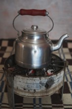 Olodschool kettle on the stove with fire charcoal