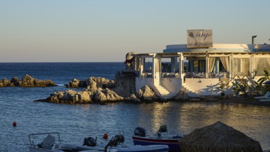Restaurant Argo, evening mood at a restaurant with sea view and small boats in front of rocky