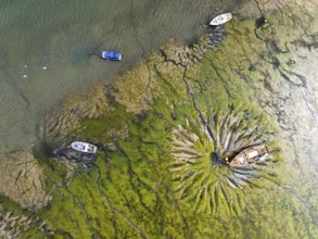 Top Down over boat and mud from drone, Paulsgrove Lake, Portchester Castle, Portchester, Fareham,