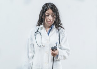 Surprised doctor with blood pressure monitor. Surprised female doctor with blood pressure monitor
