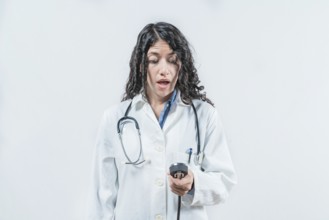 Surprised female doctor with blood pressure monitor isolated. Surprised doctor with blood pressure