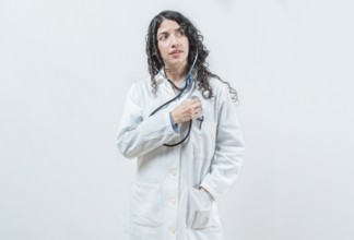 Doctor listening to her heart with stethoscope, isolated. Female doctor with stethoscope on her