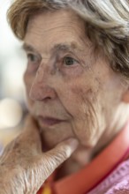 Close-up, authentic, unposed portrait of a 90+ year old senior woman with dementia and Alzheimer's