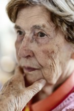 Close-up, authentic, unposed portrait of a 90+ year old senior woman with dementia and Alzheimer's