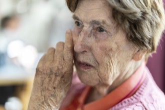 Close-up, authentic, unposed portrait of a 90+ year old senior woman with dementia and Alzheimer's