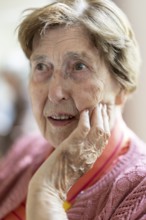 Close-up, authentic, unposed portrait of a 90+ year old senior woman with dementia and Alzheimer's