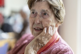 Close-up, authentic, unposed portrait of a 90+ year old senior woman with dementia and Alzheimer's
