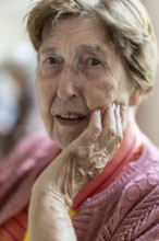 Close-up, authentic, unposed portrait of a 90+ year old senior woman with dementia and Alzheimer's