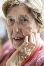 Close-up, authentic, unposed portrait of a 90+ year old senior woman with dementia and Alzheimer's