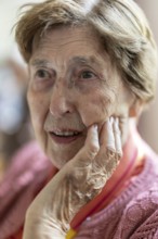 Close-up, authentic, unposed portrait of a 90+ year old senior woman with dementia and Alzheimer's