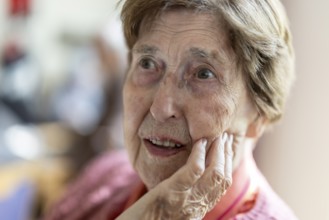 Close-up, authentic, unposed portrait of a 90+ year old senior woman with dementia and Alzheimer's
