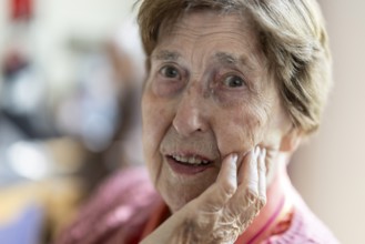 Close-up, authentic, unposed portrait of a 90+ year old senior woman with dementia and Alzheimer's