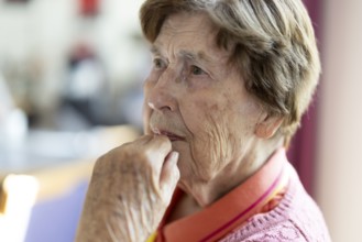 Close-up, authentic, unposed portrait of a 90+ year old senior woman with dementia and Alzheimer's