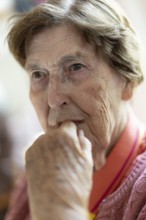 Close-up, authentic, unposed portrait of a 90+ year old senior woman with dementia and Alzheimer's
