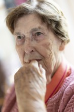 Close-up, authentic, unposed portrait of a 90+ year old senior woman with dementia and Alzheimer's
