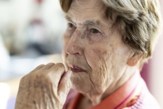 Close-up, authentic, unposed portrait of a 90+ year old senior woman with dementia and Alzheimer's