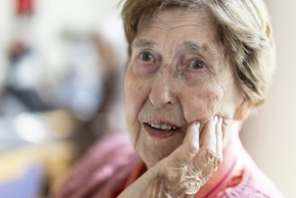 Close-up, authentic, unposed portrait of a 90+ year old senior woman with dementia and Alzheimer's