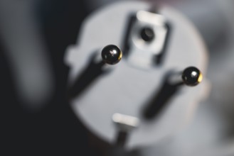 Close-up of a power plug, Schuko plug, with focus on the contact pins, symbol image for,
