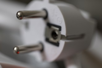 Close-up of a power plug, Schuko plug, with focus on the contact pins, symbol image for,