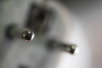 Close-up of a power plug, Schuko plug, with focus on the contact pins, symbol image for,