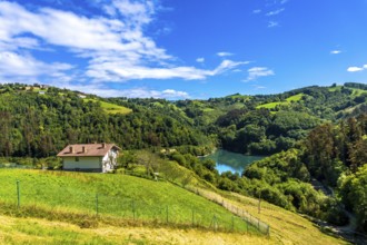 Surrounded by green rolling hills and lush forests, the tranquil ibiur reservoir features a