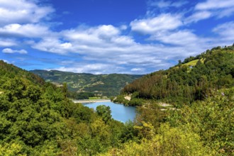 Serene ibiur reservoir nestled among lush hills of tolosa in the basque country, featuring a
