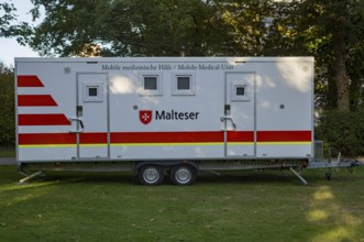 Borken, NRW, Germany, Mobile medical unit from malteser parked on grass, ready to offer medical