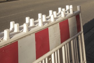 Borken, NRW, Germany, Red and white striped traffic barrier standing on a city street, ensuring