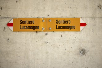 Hiking trail sign in subway on concrete, Sentiero Lucomagno, Lukmanier Trail, Campra, Blenio,