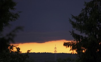 Landscape in the evening with high-voltage pylon, Germany