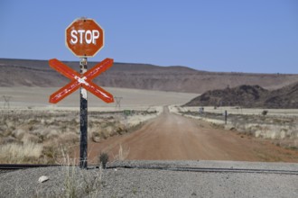 Stop sign at an ungated level crossing on the Lüderitz-Keetmanshoop railway line, near Goageb,