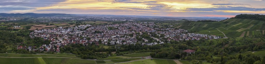 Tranquil twilight view of a town surrounded by green fields and rolling hills, Korb im Remstal,