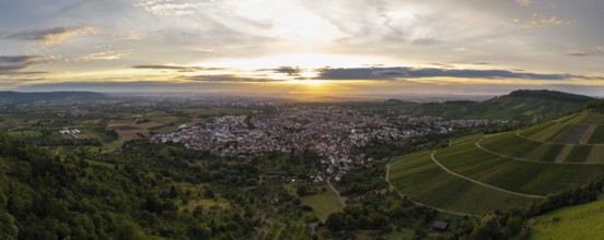 View of a town at sunset, surrounded by green hills and fields, Korb im Remstal, Baden-Württemberg,