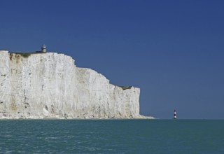 White cliffs with lighthouse under blue sky and turquoise sea, Beachy Head Lighthouse, Bournemouth,