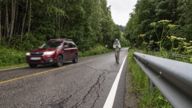 Pilgrims on a wet road, Olavsweg or Olavsleden, near Eidsvoll, Norway