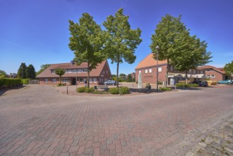 Street, bollards, trees, bench, 1000 year fountain, lantern, clinker brick pavement, concrete