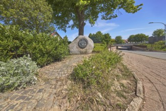Monument, political event, reunification, flower bed, bushes, trees, cobblestone path, frog