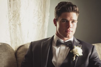 Handsome groom in elegant costume before the weeding waiting to join his bride, AI generated