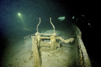 Gloomy shipwreck in Lake Constance, illuminated by rays of light and overgrown with quagga triangle
