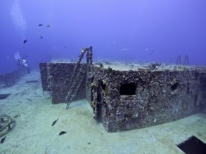 Rusty shipwreck with corals and fish in deep water. Dive site wreck of the USS Spiegel Grove, John