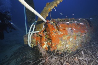 Underwater photo with diver, propeller of an aeroplane and rope in the ocean. Dive site aircraft