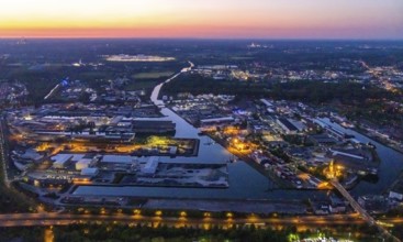Aerial view, night view of Dortmund harbour, historical building old harbour office, container