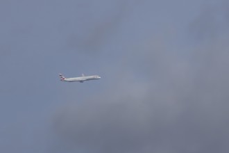 Boeing 787-9 Dreamliner jet passenger aircraft of British Airways airlines in flight in a blue sky,