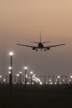 Boeing 737 jet aircraft of Ryanair airlines in flight landing at sunset at London Stansted airport,