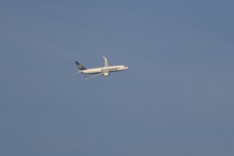 Boeing 737 jet passenger aircraft of Ryanair airlines in flight in a blue sky, Rome, Italy