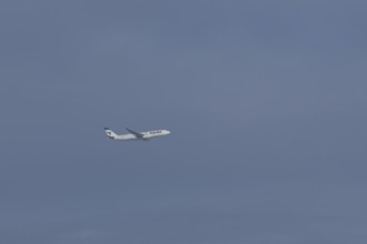 Jet passenger aircraft of Iran Air Airlines flying in a blue sky, England, United Kingdom