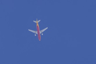 Boeing 767 jet aircraft of DHL cargo airlines in flight in a blue sky, England, United Kingdom